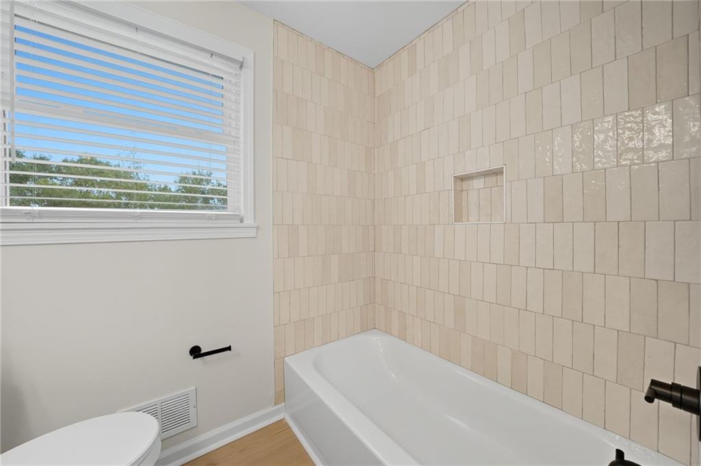 9 Chestnut Street Cartersville, GA 30120 - Photo 18 of 45 a white bath tub sitting next to a white toilet