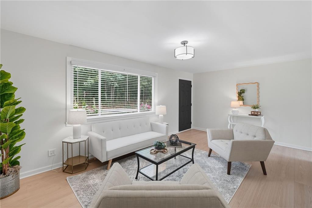 9 Chestnut Street Cartersville, GA 30120 - Photo 2 of 45 a living room with furniture and a potted plant