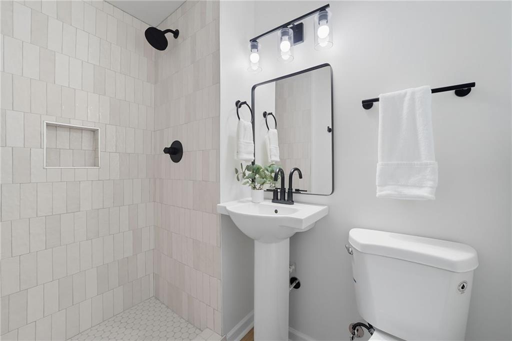 9 Chestnut Street Cartersville, GA 30120 - Photo 23 of 45 a bathroom with a sink a toilet and shower