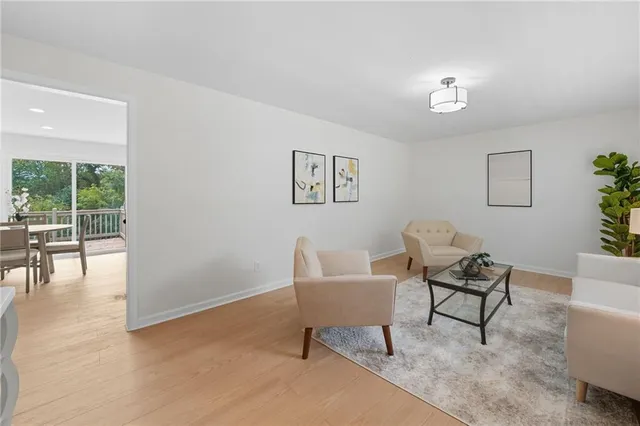a view of a livingroom with furniture and a window