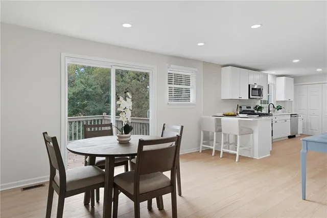 a dining room with furniture and window