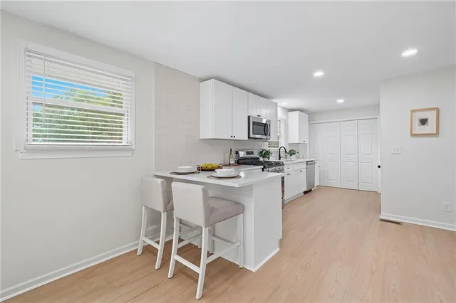 a kitchen with a sink cabinets and wooden floor