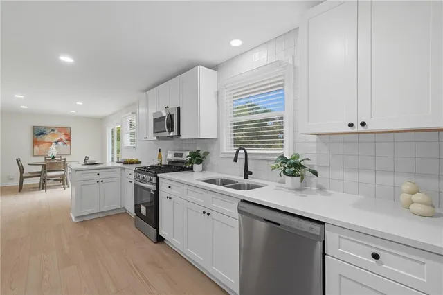 a kitchen with sink cabinets and window
