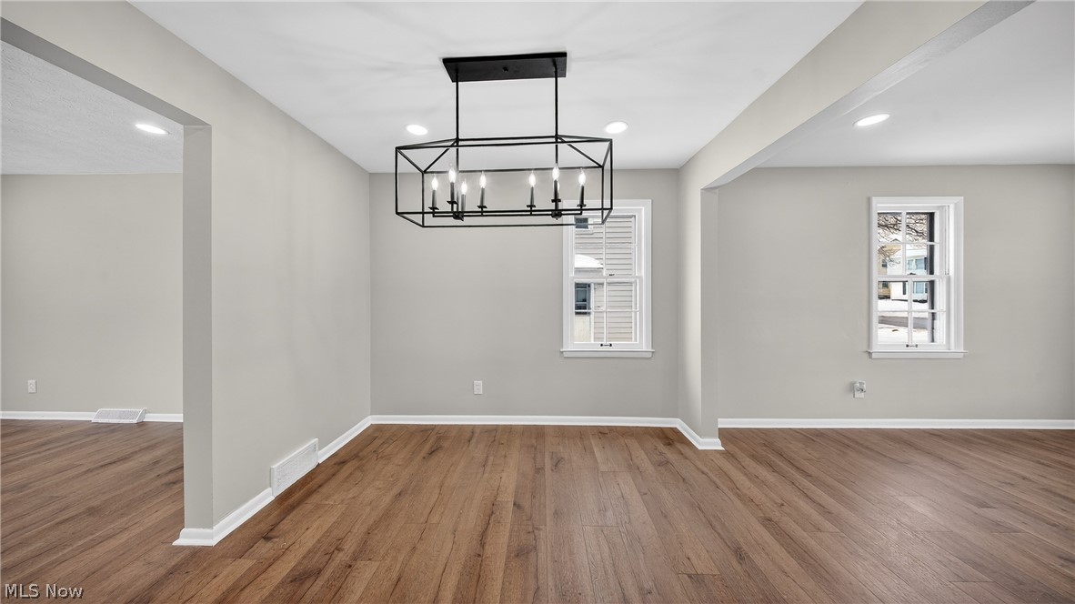 16811 Invermere Avenue Cleveland, OH 44128 - Photo 12 of 47 Unfurnished dining area with wood finished floors, plenty of natural light, recessed lighting, and a chandelier
