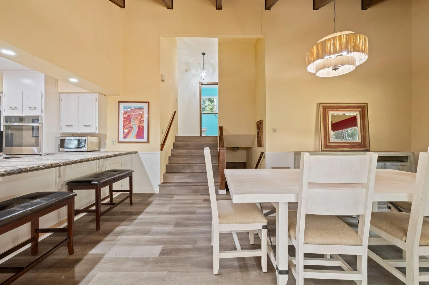 24014 Pine Cone Road Twain Harte, CA 95383 - Photo 16 of 43 a dining room with wooden floor and stainless steel appliances