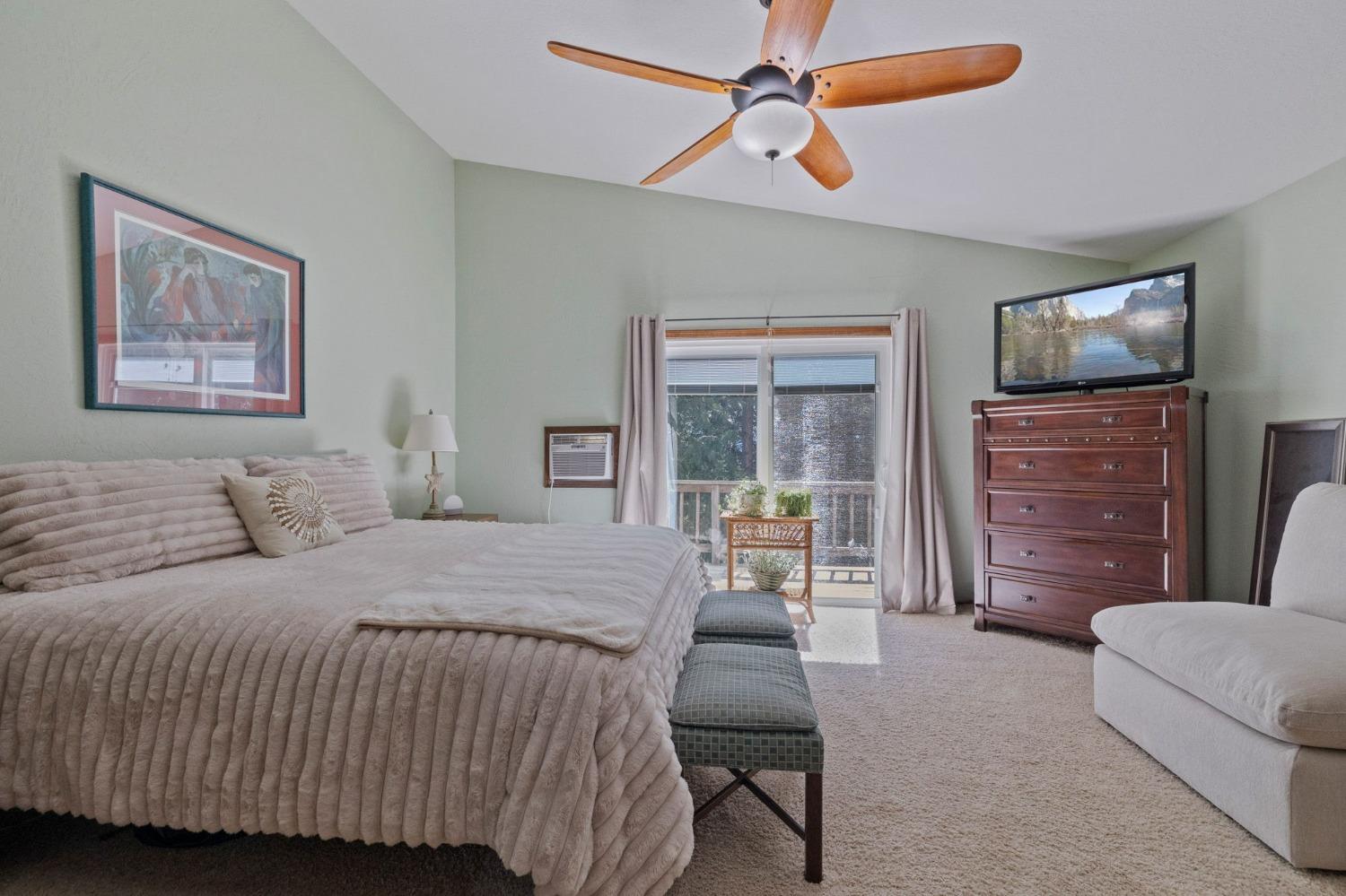 24014 Pine Cone Road Twain Harte, CA 95383 - Photo 23 of 43 a bedroom with a bed couch and a flat tv screen