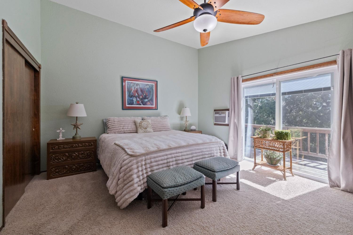 24014 Pine Cone Road Twain Harte, CA 95383 - Photo 24 of 43 a bedroom with a bed and a chandelier