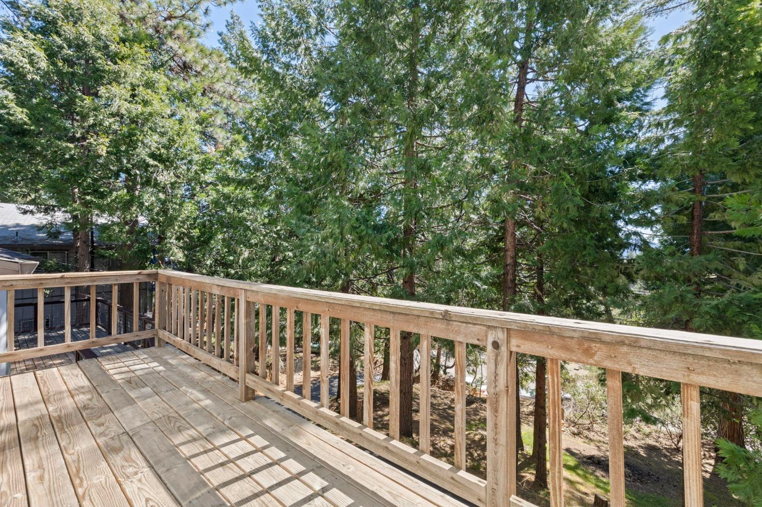 24014 Pine Cone Road Twain Harte, CA 95383 - Photo 26 of 43 a balcony with wooden floor and fence