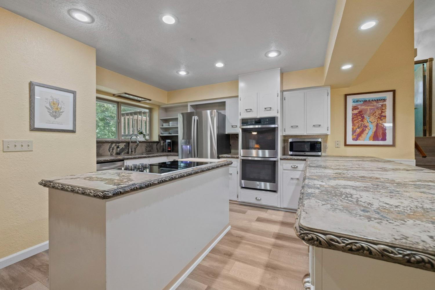 24014 Pine Cone Road Twain Harte, CA 95383 - Photo 3 of 43 a kitchen with stainless steel appliances granite countertop a stove top oven a sink and a refrigerator