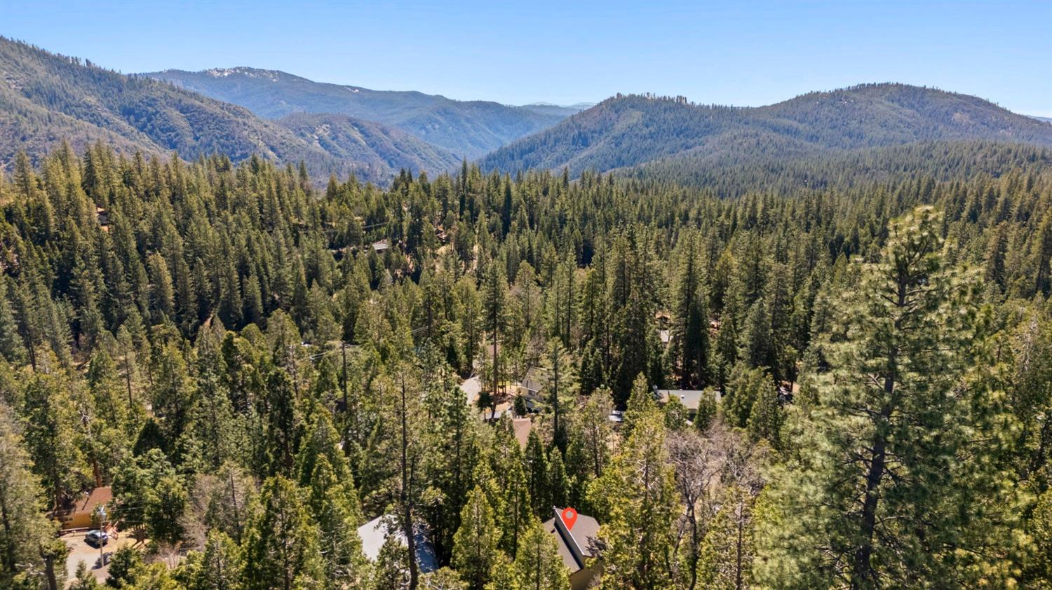 24014 Pine Cone Road Twain Harte, CA 95383 - Photo 40 of 43 a view of a lush green hillside and a houses
