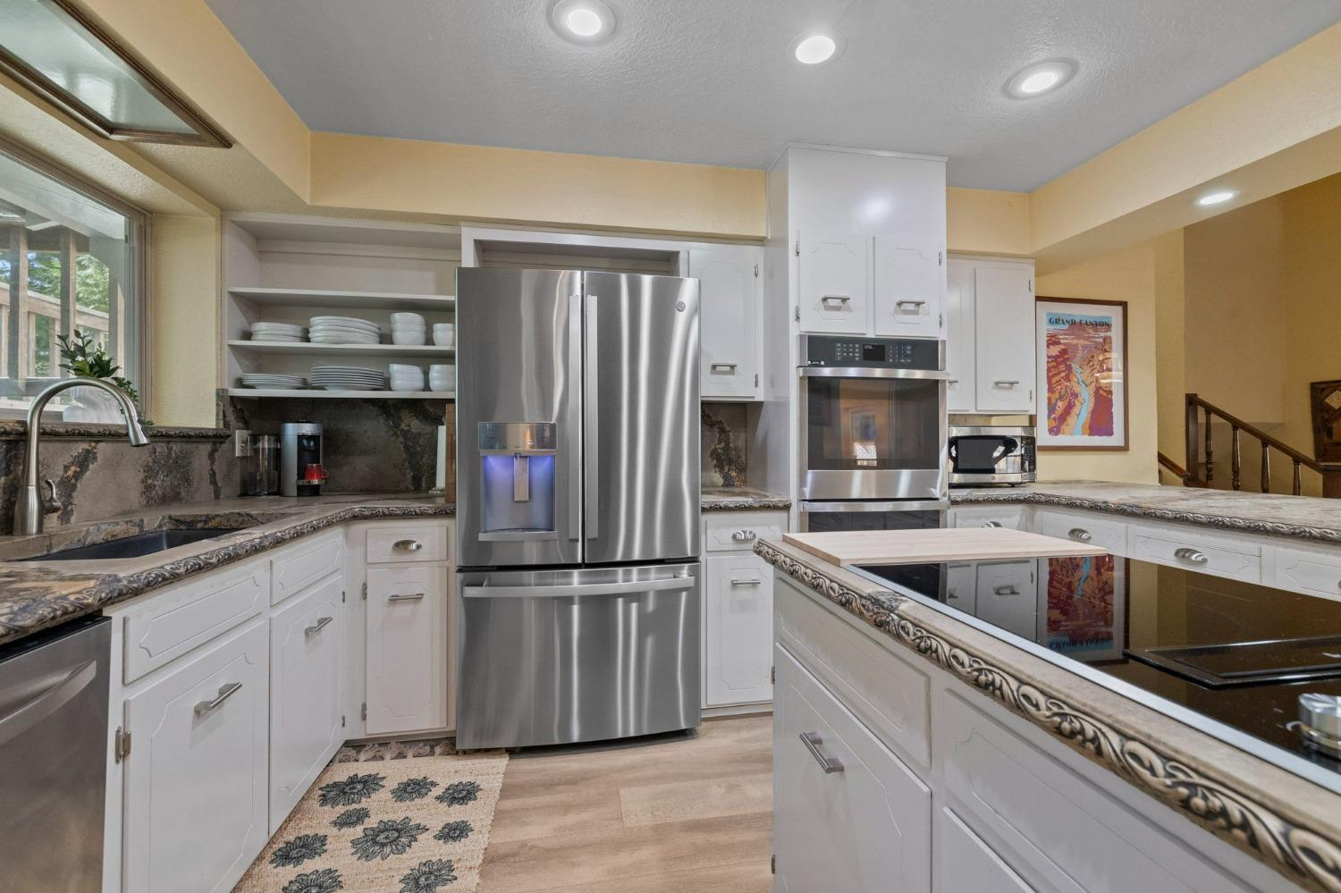 24014 Pine Cone Road Twain Harte, CA 95383 - Photo 4 of 43 a kitchen with granite countertop a refrigerator and a sink