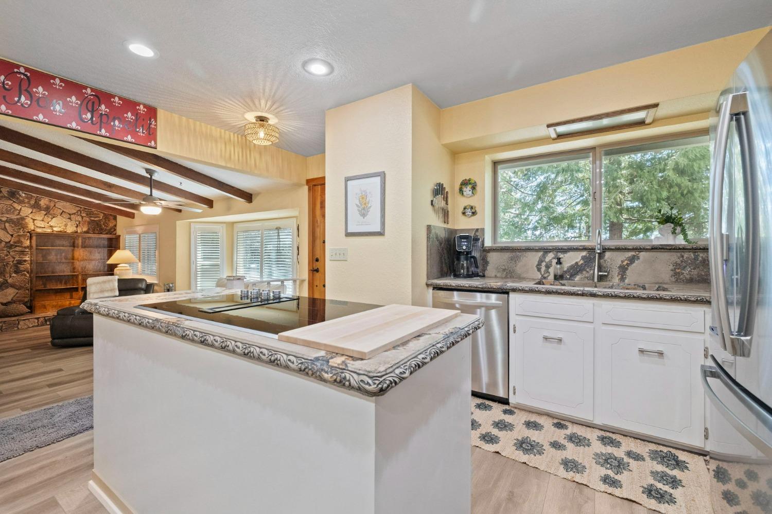 24014 Pine Cone Road Twain Harte, CA 95383 - Photo 6 of 43 a kitchen with granite countertop a sink and a stove