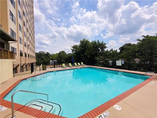 a view of a swimming pool with a yard
