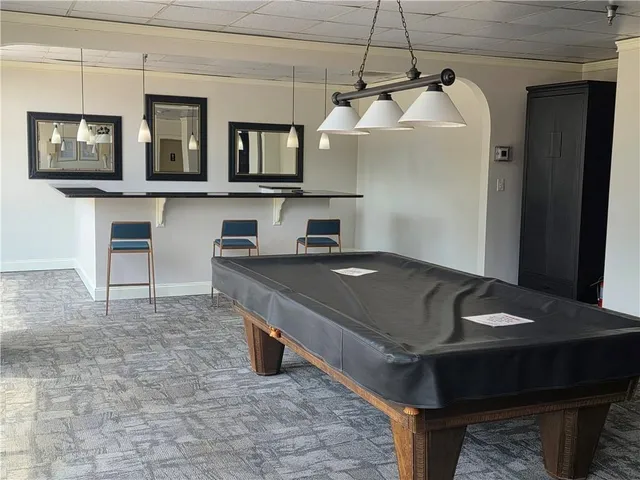 a living room with a table and chairs