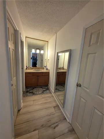 a bathroom with a sink a mirror and a shower