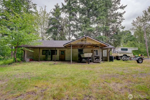 a yellow house with trees in front of it