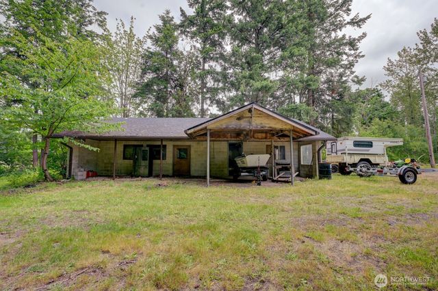 a yellow house with trees in front of it