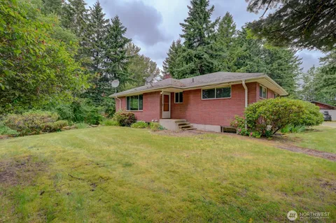 a front view of a house with yard and green space