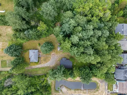 an aerial view of a house with garden space and street view