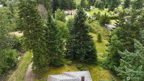 an aerial view of a house with a yard