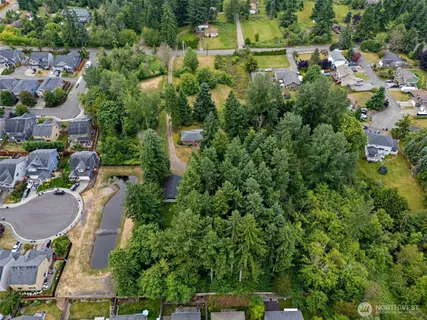 an aerial view of a house with a yard and lake view