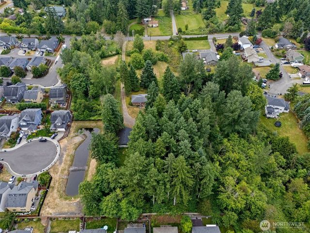 an aerial view of a house with a yard and lake view