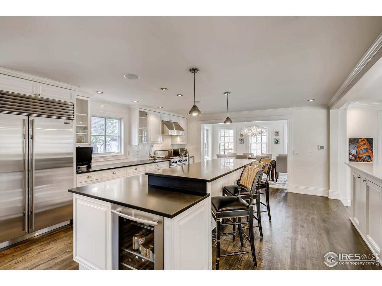 435 Valley View Drive Boulder, CO 80304 - Photo 9 of 40 a kitchen with kitchen island a dining table chairs stainless steel appliances and cabinets