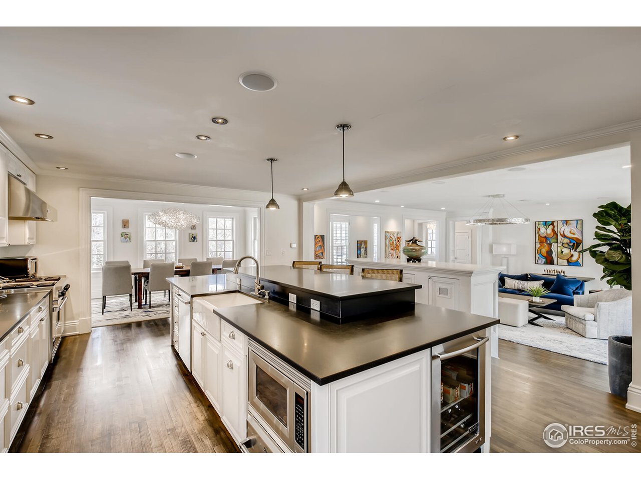 435 Valley View Drive Boulder, CO 80304 - Photo 10 of 40 a kitchen with stainless steel appliances granite countertop a stove a sink dishwasher and white cabinets with wooden floor