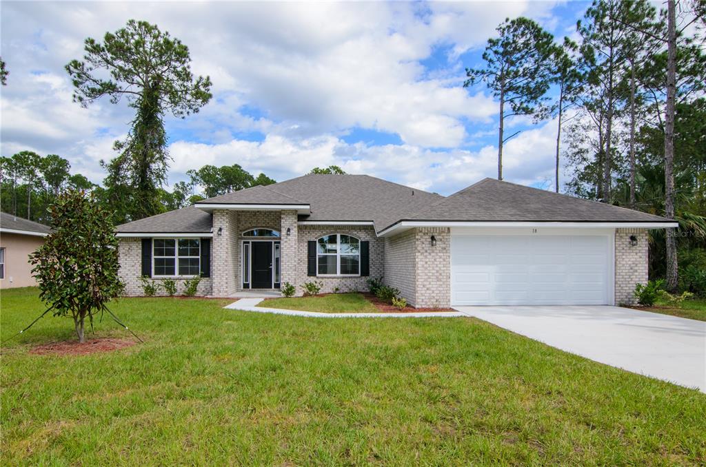 5 Red Clover Lane Palm Coast, FL 32164 - Photo 1 of 38 a front view of house with yard and green space