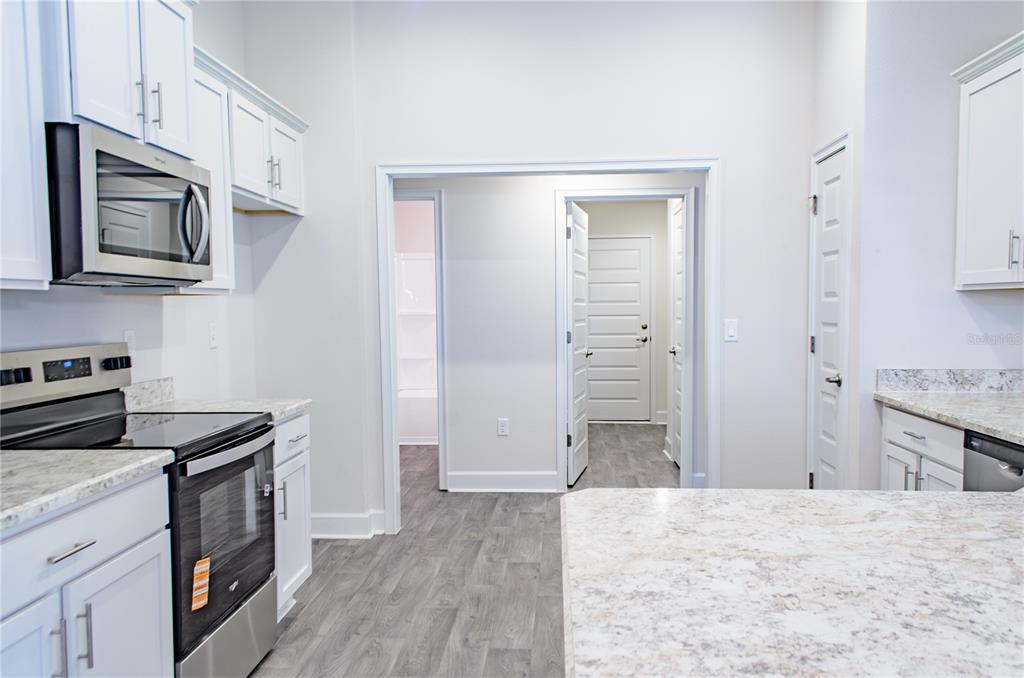 5 Red Clover Lane Palm Coast, FL 32164 - Photo 17 of 38 a kitchen with stainless steel appliances granite countertop a stove and a refrigerator