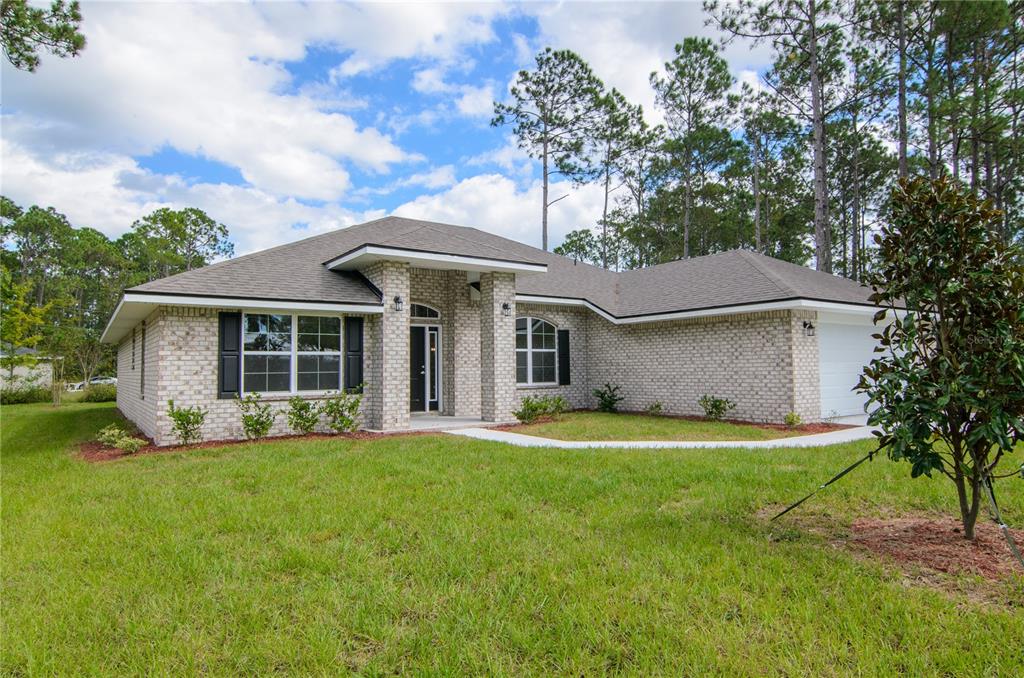5 Red Clover Lane Palm Coast, FL 32164 - Photo 2 of 38 a view of a house with a yard and sitting area
