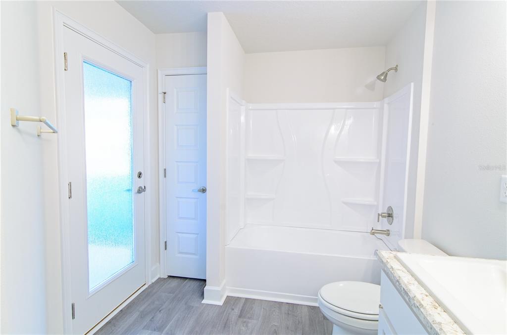 5 Red Clover Lane Palm Coast, FL 32164 - Photo 25 of 38 a bathroom with a toilet a sink and shower