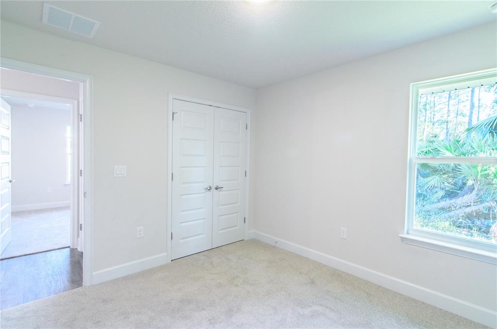 5 Red Clover Lane Palm Coast, FL 32164 - Photo 26 of 38 an empty room with windows and closet