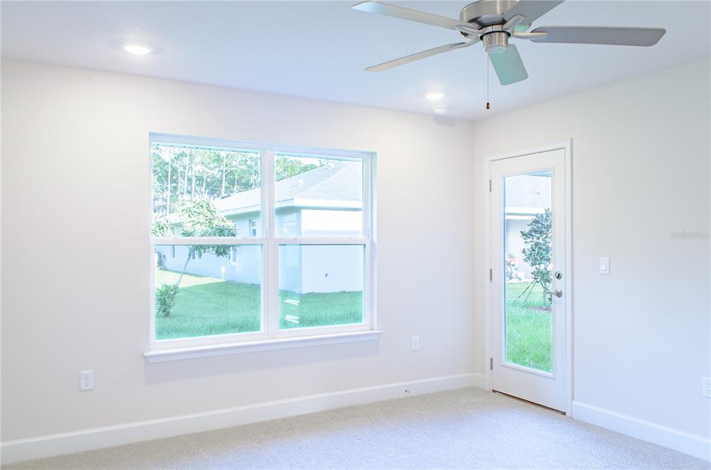 5 Red Clover Lane Palm Coast, FL 32164 - Photo 30 of 38 an empty room with windows and fan