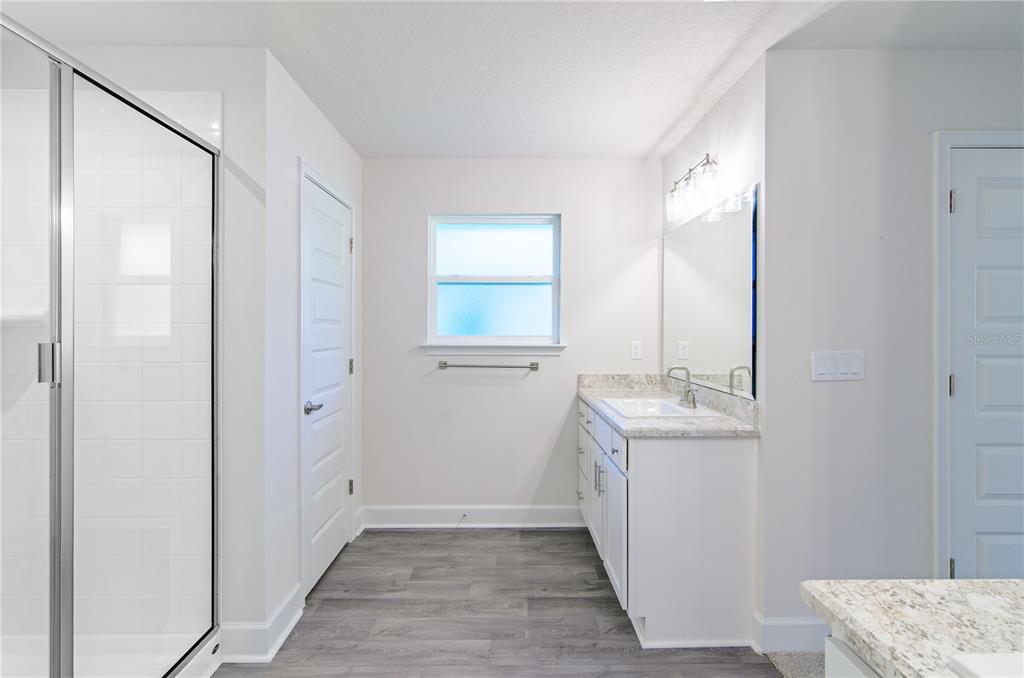 5 Red Clover Lane Palm Coast, FL 32164 - Photo 31 of 38 a bathroom with a sink a toilet and mirror