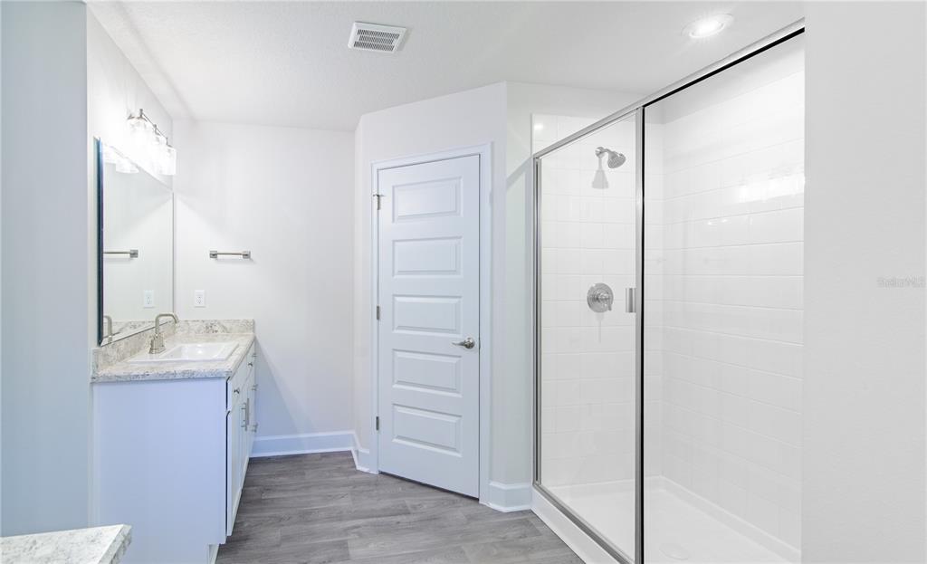 5 Red Clover Lane Palm Coast, FL 32164 - Photo 32 of 38 a bathroom with a shower sink and mirror