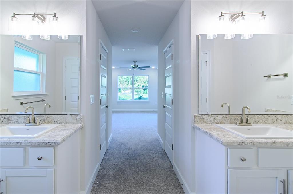 5 Red Clover Lane Palm Coast, FL 32164 - Photo 34 of 38 a bathroom with a sink double vanity and a mirror