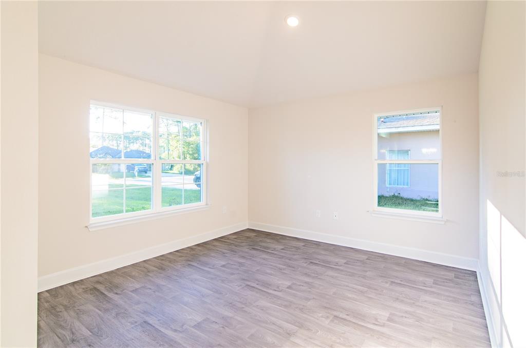5 Red Clover Lane Palm Coast, FL 32164 - Photo 9 of 38 an empty room with wooden floor and windows