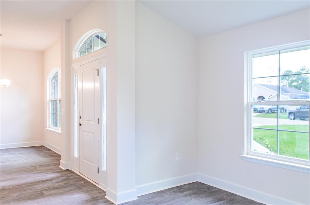 5 Red Clover Lane Palm Coast, FL 32164 - Photo 10 of 38 wooden floor in an empty room with a window
