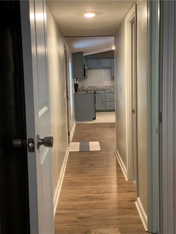 a view of a hallway with wooden floor
