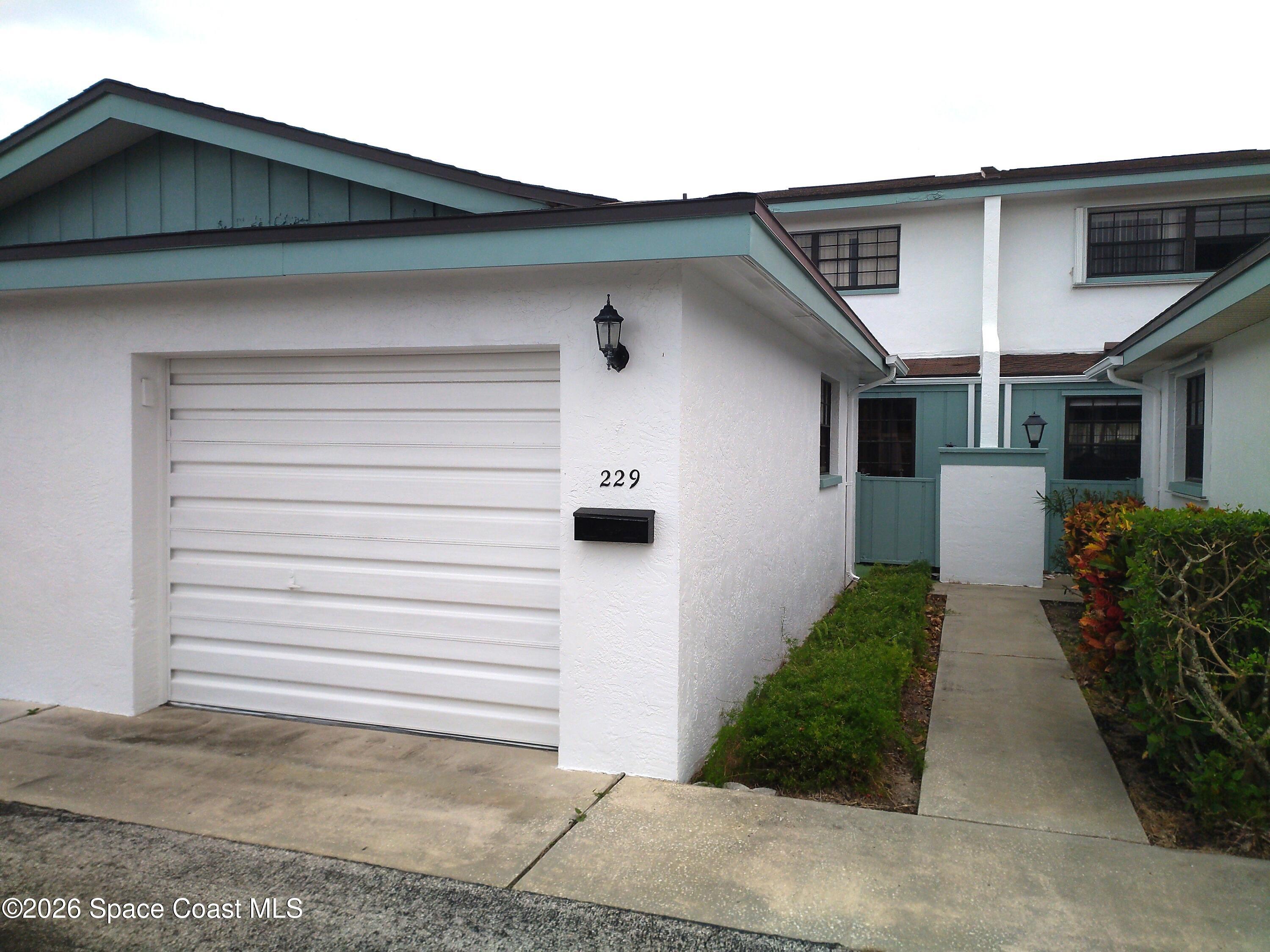 229 Kings Way Satellite Beach, FL 32937 - Photo 1 of 13 a front view of a house with garden