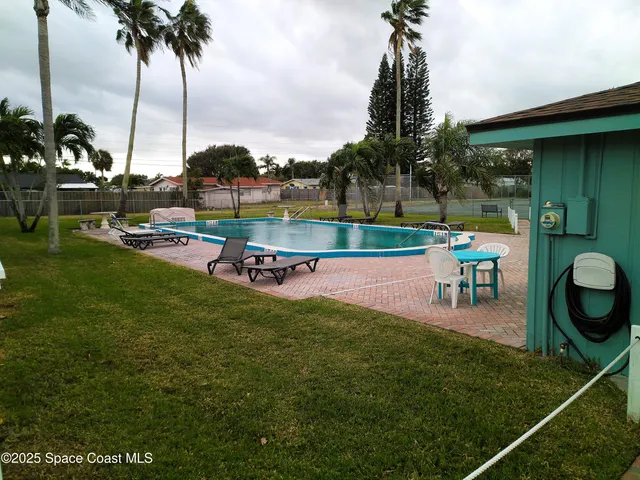 a swimming pool with outdoor seating and yard