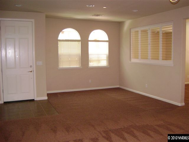 1845 A Wind Ranch Road Reno, NV 89521 - Photo 6 of 9 an empty room with a window and a ceiling fan