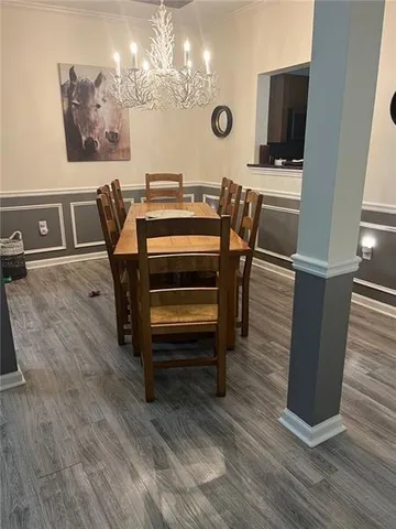 a view of a dining room with furniture and a chandelier