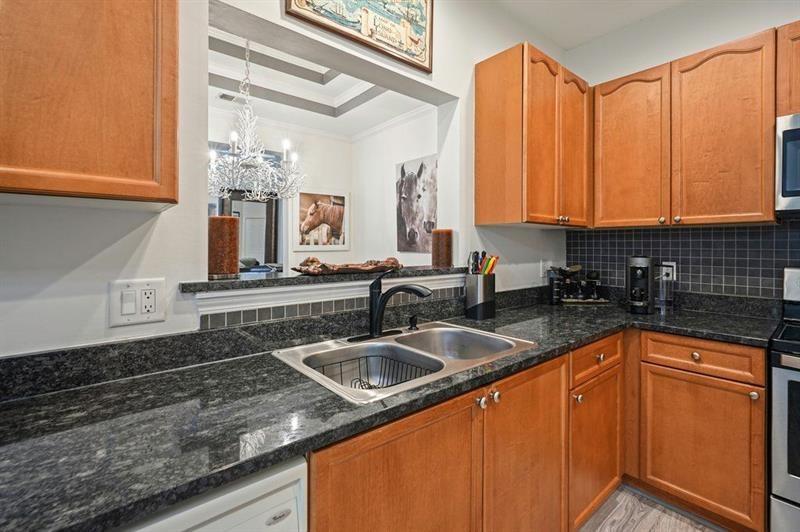 2521 Eden Ridge Lane, Unit 7 Acworth, GA 30101 - Photo 18 of 47 a kitchen with stainless steel appliances granite countertop a sink a counter space and cabinets