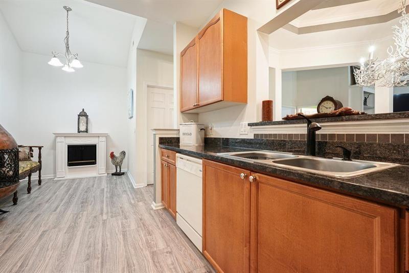 2521 Eden Ridge Lane, Unit 7 Acworth, GA 30101 - Photo 20 of 47 a kitchen with stainless steel appliances granite countertop a sink a stove and a wooden floors