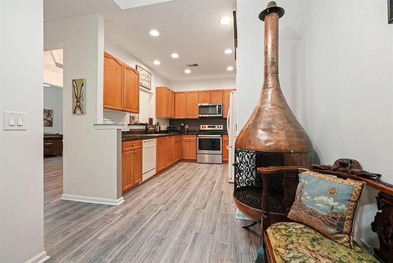 2521 Eden Ridge Lane, Unit 7 Acworth, GA 30101 - Photo 21 of 47 a kitchen with stainless steel appliances granite countertop a stove top oven a sink and cabinets