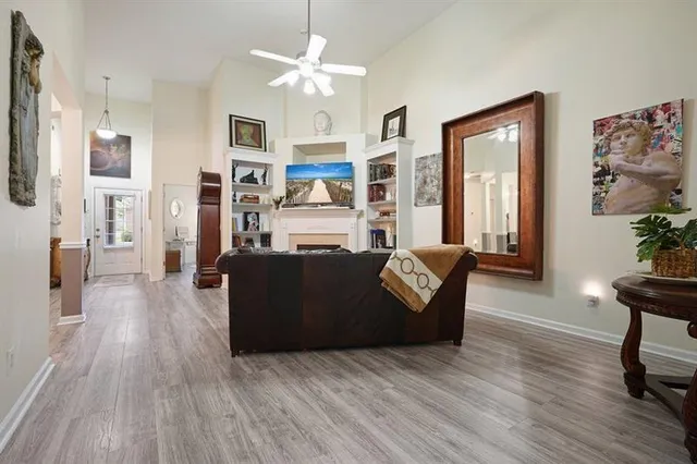 a living room with fireplace furniture and a wooden floor