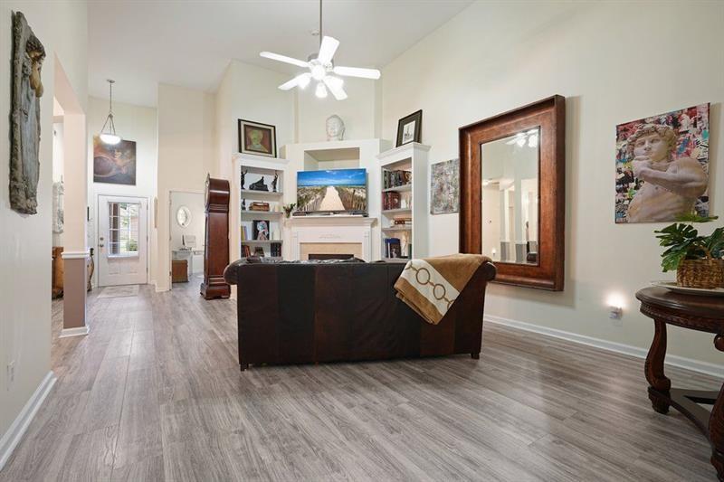 2521 Eden Ridge Lane, Unit 7 Acworth, GA 30101 - Photo 23 of 47 a living room with fireplace furniture and a wooden floor