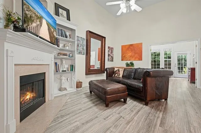 a living room with furniture a fireplace and a flat screen tv